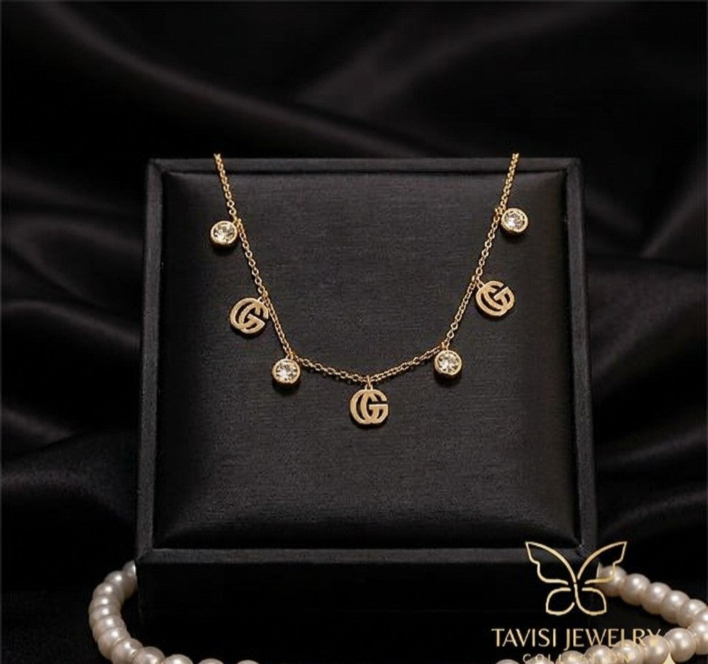 gold gg charm tanmaniya necklace anti tarnish
waterproof gg necklace stainless steel jewellery
trendy gg charm gold necklace daily wear
anti tarnish gg letter necklace lightweight
stainless steel gold gg necklace with stones