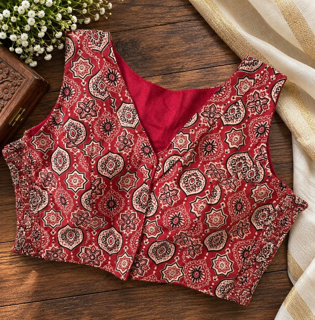 Black and rust Ajrakh printed sleeveless cotton saree blouse styled with traditional ethnic wear