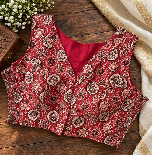 Black and rust Ajrakh printed sleeveless cotton saree blouse styled with traditional ethnic wear