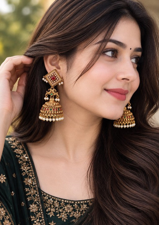 Alloy Kundan-style pearl jhumka earrings with ruby red green and multicolor stones worn by a woman