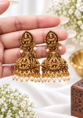 Black and gold Lakshmi jhumka earrings with intricate temple-inspired detailing and white pearl drops