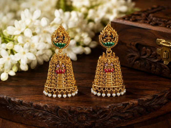 Devika Antique Brass Raja Gopuram Meenakari Jhumka earrings with green accents and pearl drop detailing