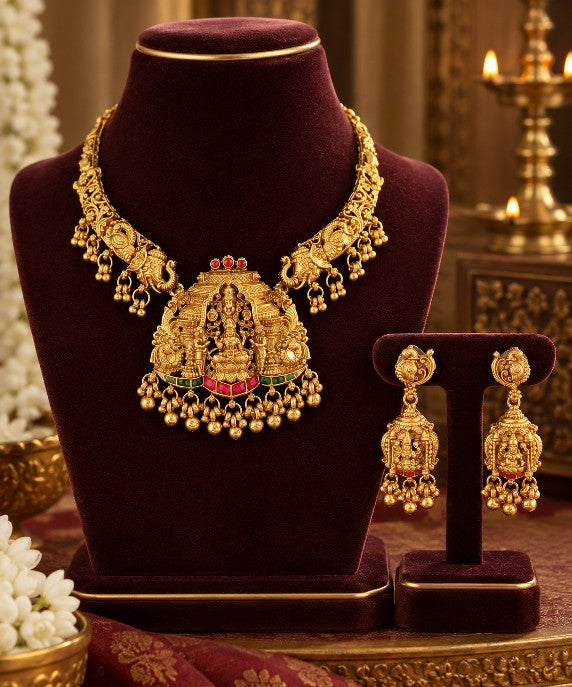 Heavy South Indian Lakshmi necklace set with rich gold tone finish, traditional temple jewellery detailing and matching earrings