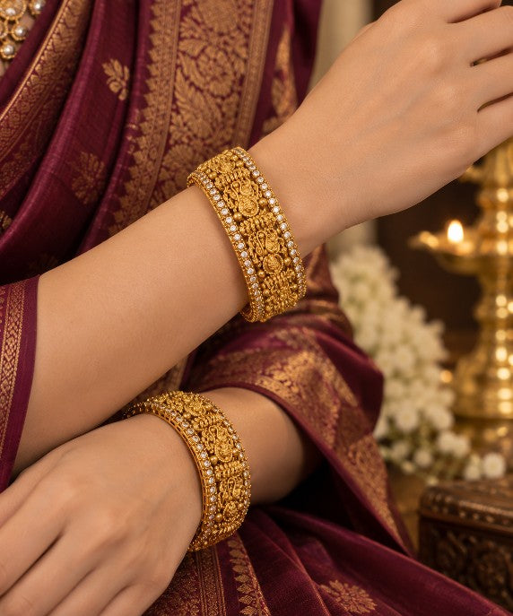 Heavy South Indian Lakshmi bangles featuring intricate traditional motifs, decorative stones, copper base and gold tone finish