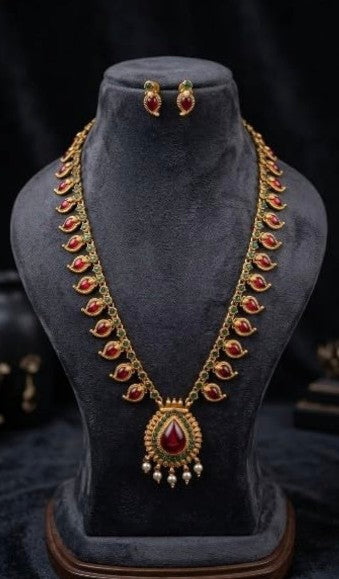 Mango Palakka emerald stone long haram with ruby-coloured accents, large green pendant and pearl drops, traditional South Indian jewellery for women