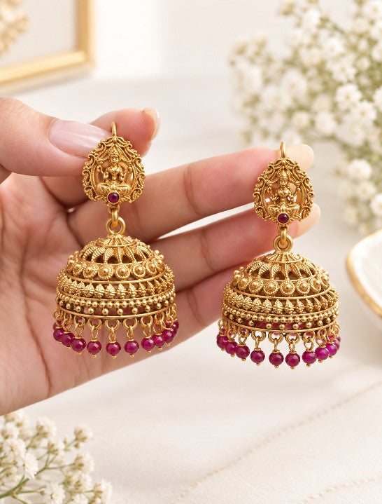South Indian gold plated Lakshmi jhumka earrings with green bead drops, traditional temple jewellery and Goddess Lakshmi design