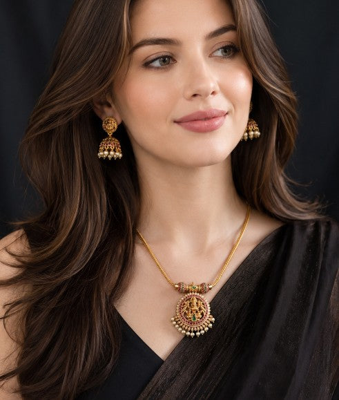 Lakshmi gold plated brass pendant necklace set with AD stones, ruby detailing and matching jhumka earrings, premium South Indian jewellery for women