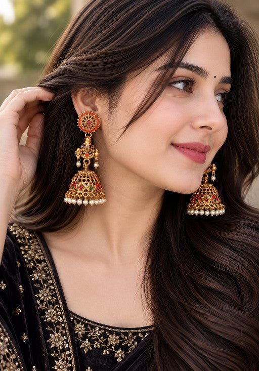 Tirupati Venkateswara inspired traditional jhumka with multicolour stones and white pearl fringe worn by a woman