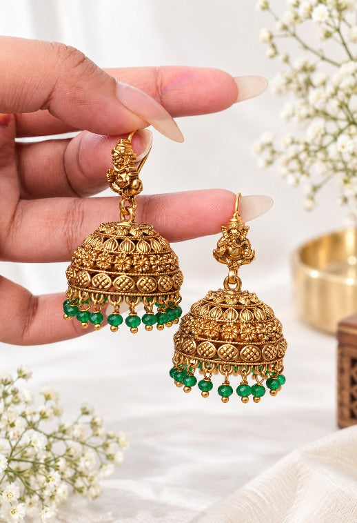 Vignesh gold plated hook jhumka earrings with intricate South Indian temple jewellery detailing and green bead drops