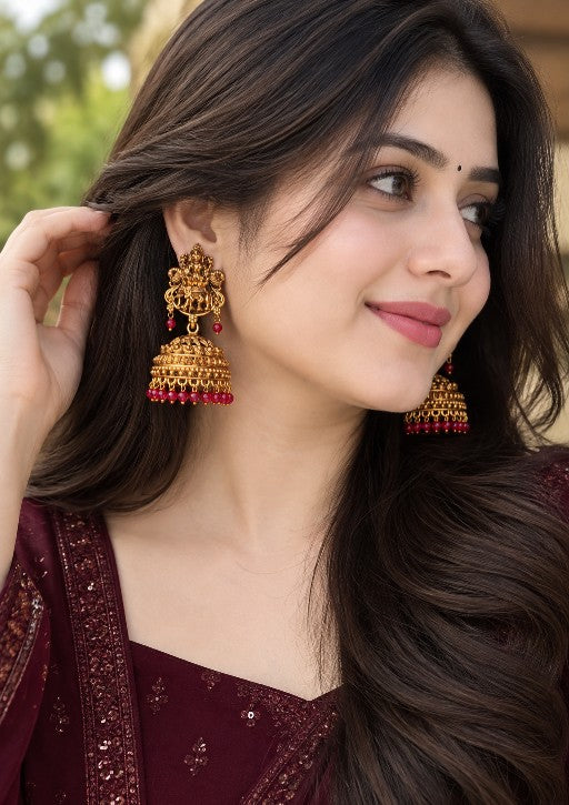 Woman wearing alloy Vijayalakshmi Lakshmi Devi jhumka earrings with red bead drops