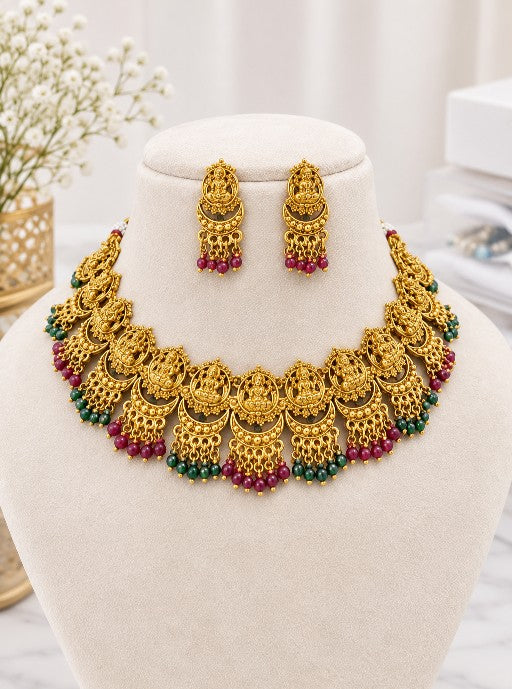 Aadhira Lakshmi South Indian bridal necklace set with matching earrings and green and ruby bead detailing