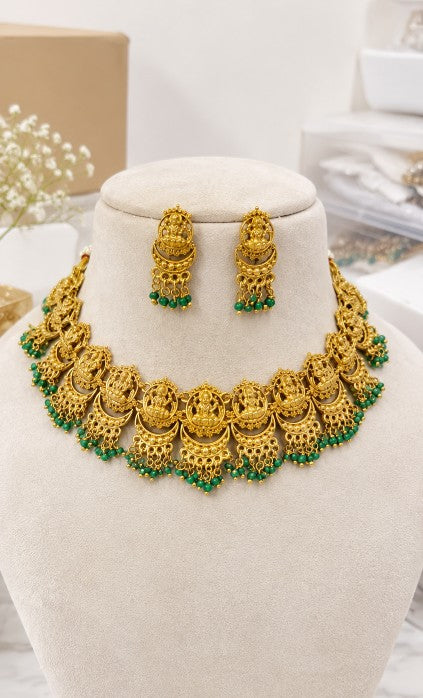Aadhira Lakshmi traditional necklace set with matching earrings and green bead detailing