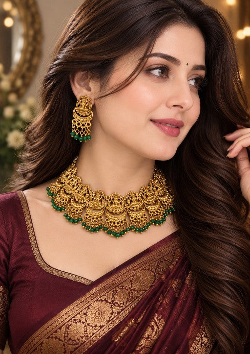 Indian woman wearing Aadhira Lakshmi traditional bridal necklace set with matching earrings and green bead detailing