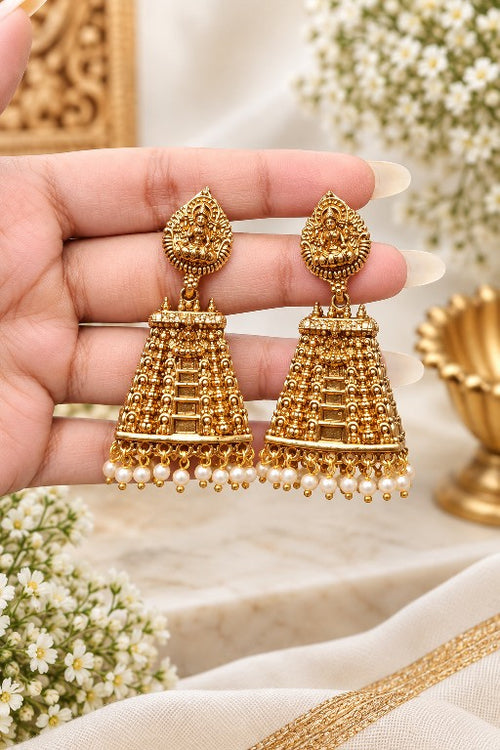 Aadhira premium brass Lakshmi temple jhumka earrings with pearl drops in gold finish