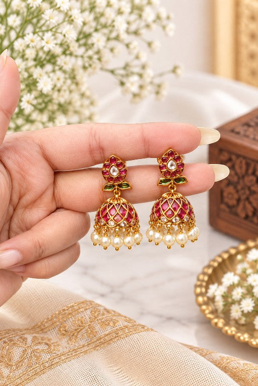 Aaradhya premium brass floral pearl jhumka earrings with pink green Kemp-style detailing and gold finish