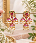 Aaradhya premium brass Kemp pearl jhumka earrings with pink green stones and triple dome design