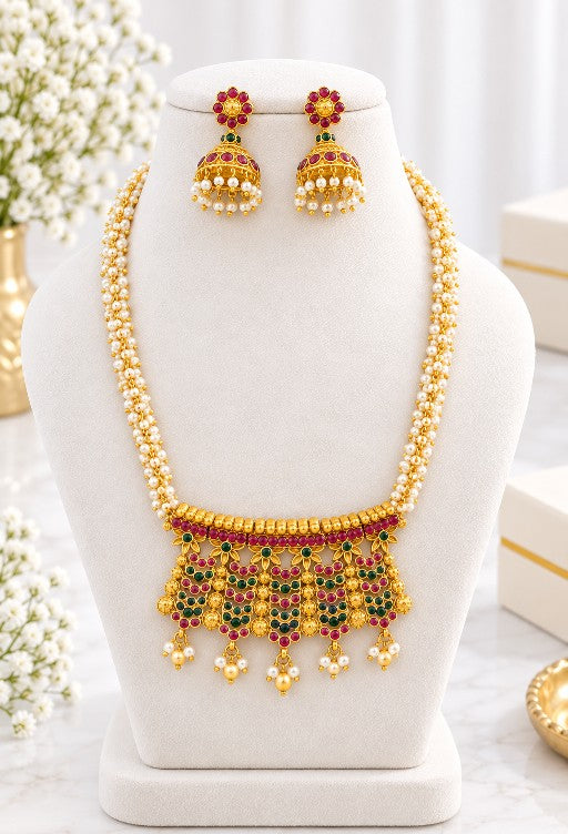 Woman wearing Aarini Mehendi Gold pearl pendant necklace and jhumka set with saree