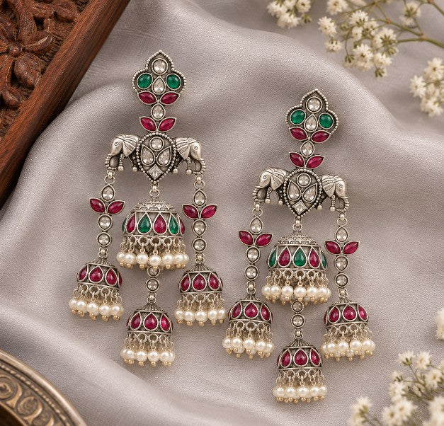 Avyara green and ruby elephant motif jhumka earrings with pearl drops