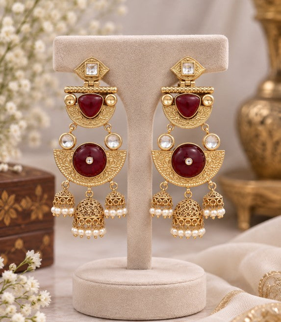 Close-up of Avyara ruby green jhumka earrings with AD stones and pearl drops