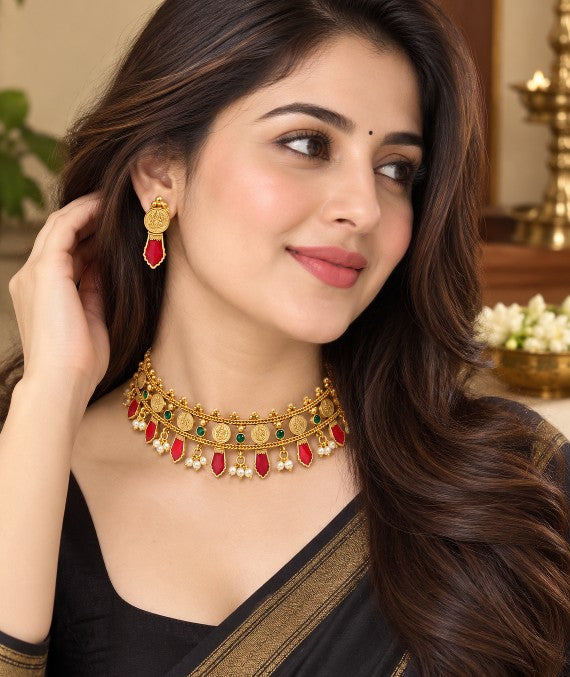Woman wearing Avyukta Ruby Palakka coin layer choker necklace with matching earrings