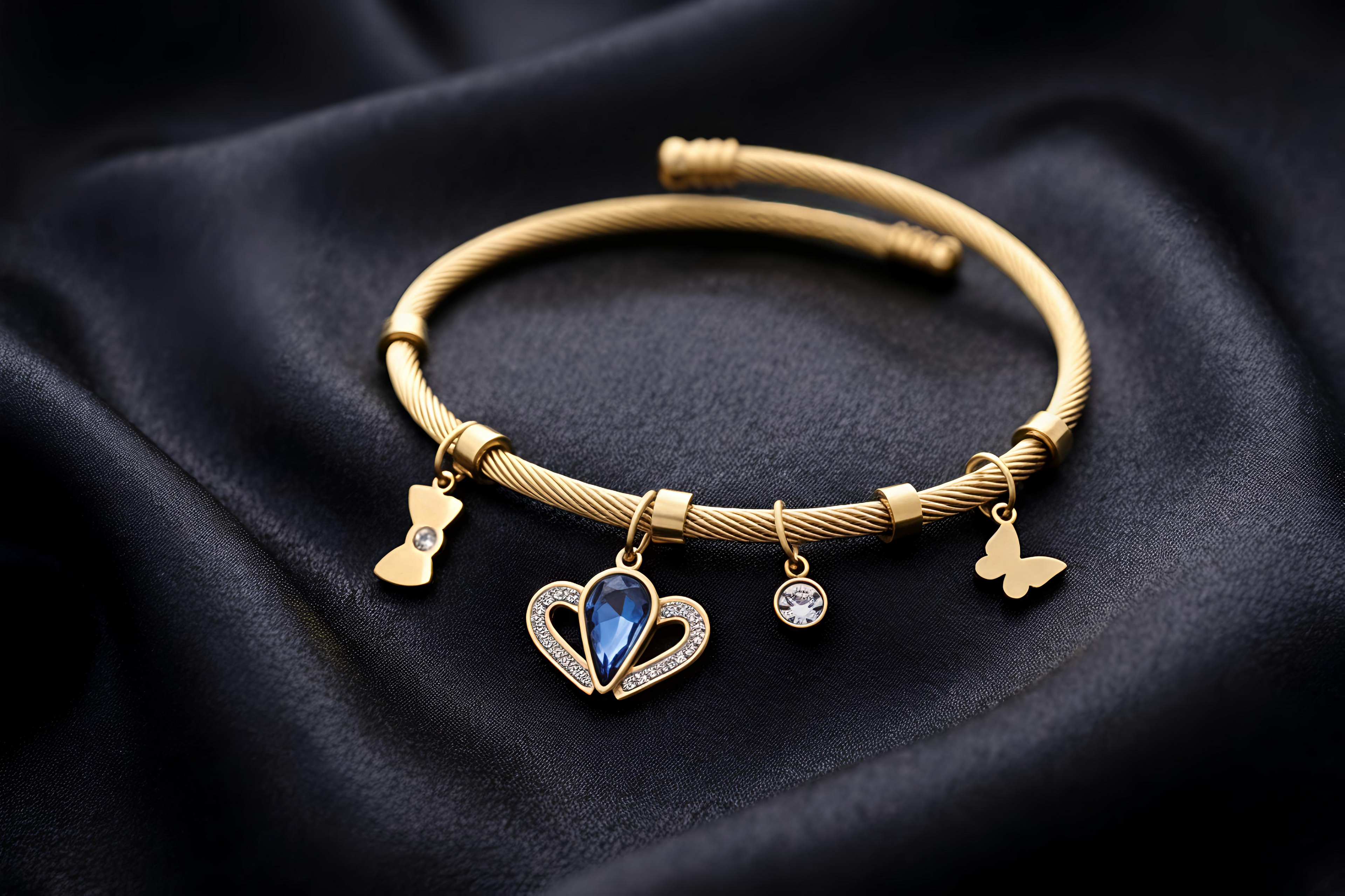 Close-up view of Tavisi Celeste Blue Charm Bracelet with gold finish, zircon accents and elegant charm details.