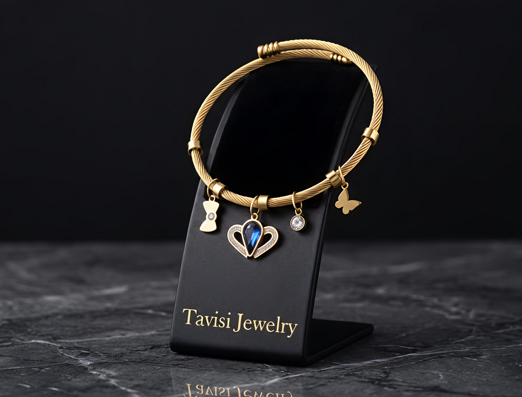 Tavisi Celeste Blue Charm Bracelet featuring a blue crystal centre charm, butterfly charms and anti-tarnish stainless steel construction.