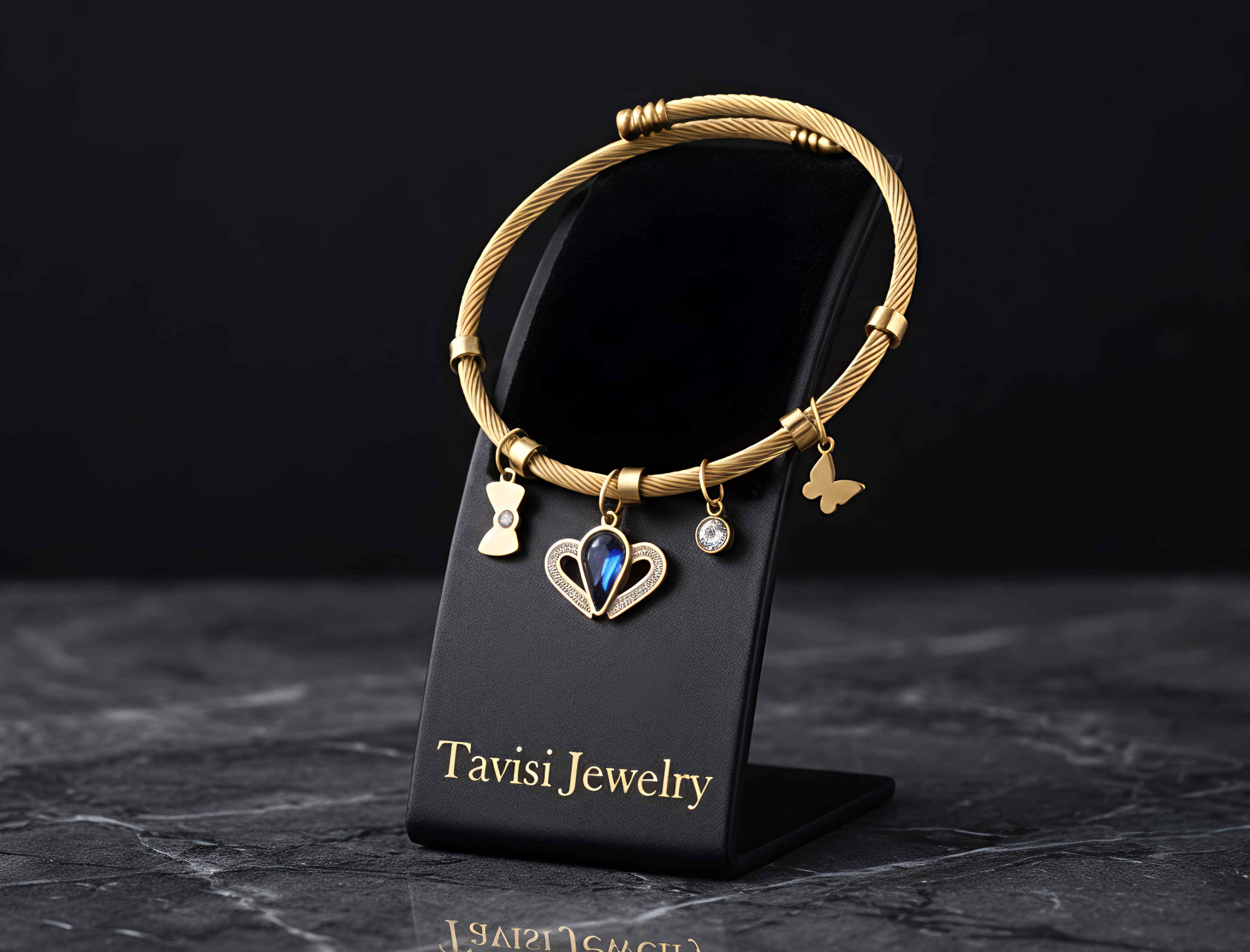 Tavisi Celeste Blue Charm Bracelet featuring a blue crystal centre charm, butterfly charms and anti-tarnish stainless steel construction.
