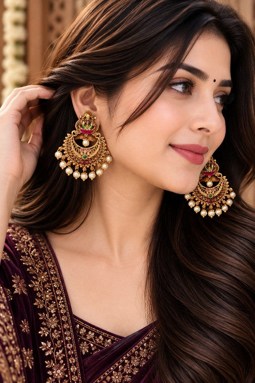 Woman wearing Devika premium brass Lakshmi Chandbali earrings with pearl drops in Mehendi finish