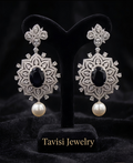 Tavisi Elara Midnight Mandala Drops featuring navy blue centre stones, sparkling AD stones and elegant pearl accents.