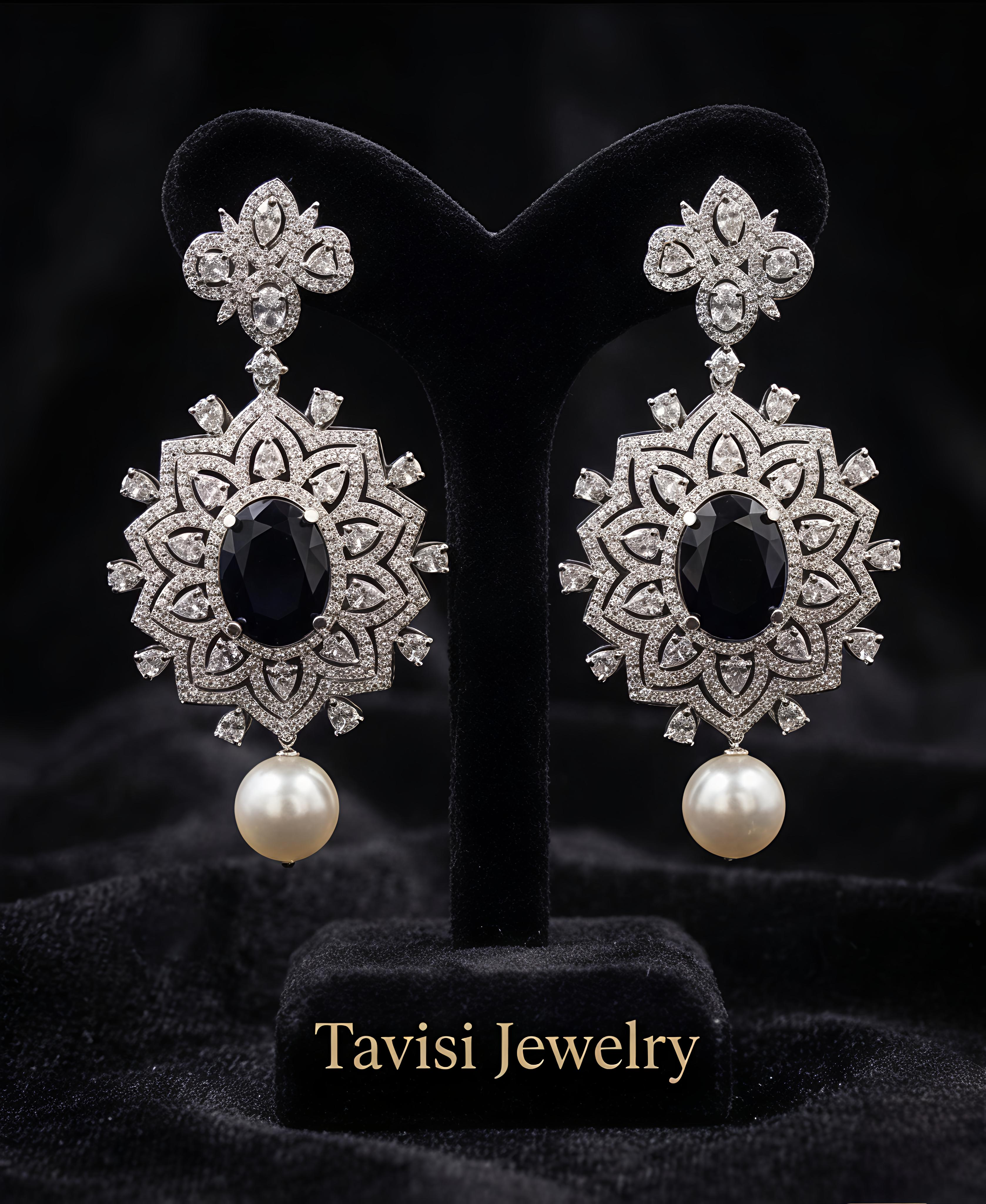 Tavisi Elara Midnight Mandala Drops featuring navy blue centre stones, sparkling AD stones and elegant pearl accents.