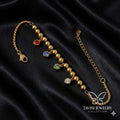 Gold Bead Multi-Colour CZ Charm Bracelet with red blue green crystal drops on white fabric - Tavisi Jewelry Collection