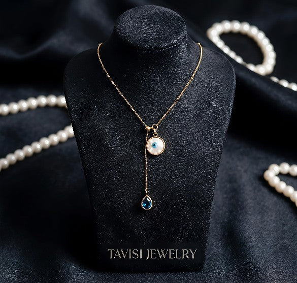 Gold Evil Eye Chain Pendant Necklace with Blue Stone Drop worn by model - Tavisi Jewelry Collection