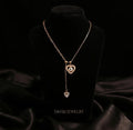 Gold Evil Eye Heart Drop Necklace with CZ Stones worn by model - Tavisi Jewelry Collection