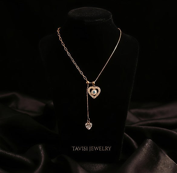 Gold Evil Eye Heart Drop Necklace with CZ Stones worn by model - Tavisi Jewelry Collection