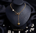 Gold Heart Toggle Drop Necklace with Dual Heart Charm worn by model - Tavisi Jewelry Collection