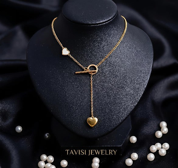Gold Heart Toggle Drop Necklace with Dual Heart Charm worn by model - Tavisi Jewelry Collection