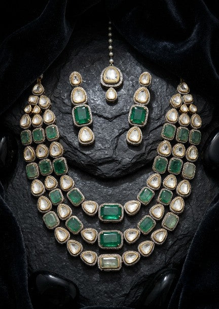 Premium brass green Kundan AD bridal necklace set front view.