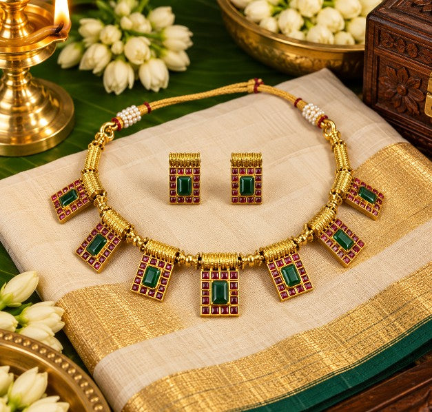 Ishani green and ruby necklace set displayed with traditional Indian saree styling