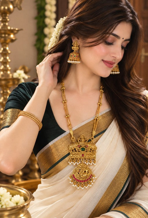 Woman wearing Kavya antique gold Lakshmi pendant necklace and matching Jhumka earrings