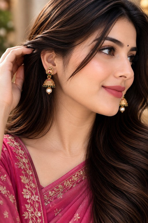 Woman wearing Meenakshi mini AD stone pearl jhumka earrings with pink green detailing