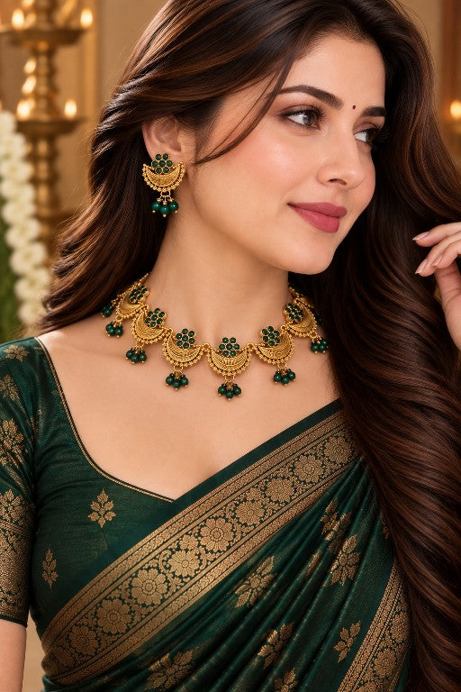 Woman wearing Mehira green paisley necklace set with earrings