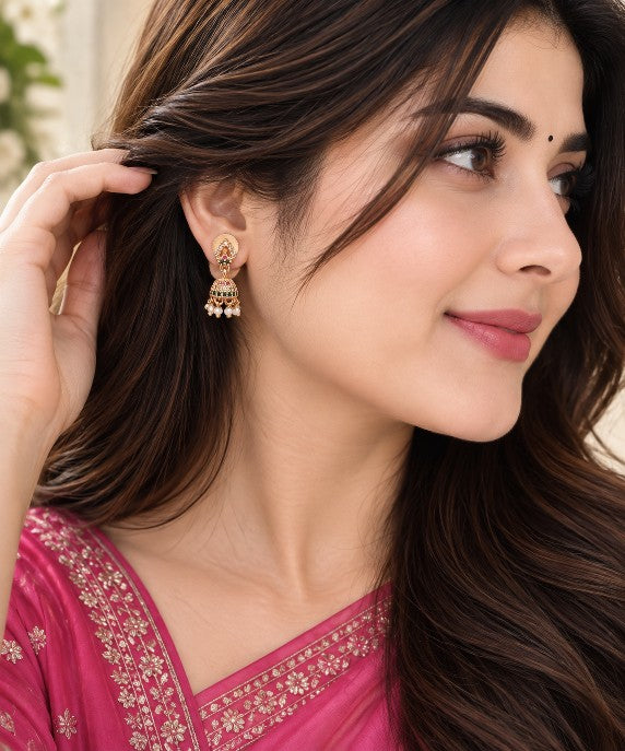 Woman wearing Nandini mini AD stone pearl jhumka earrings with green red detailing