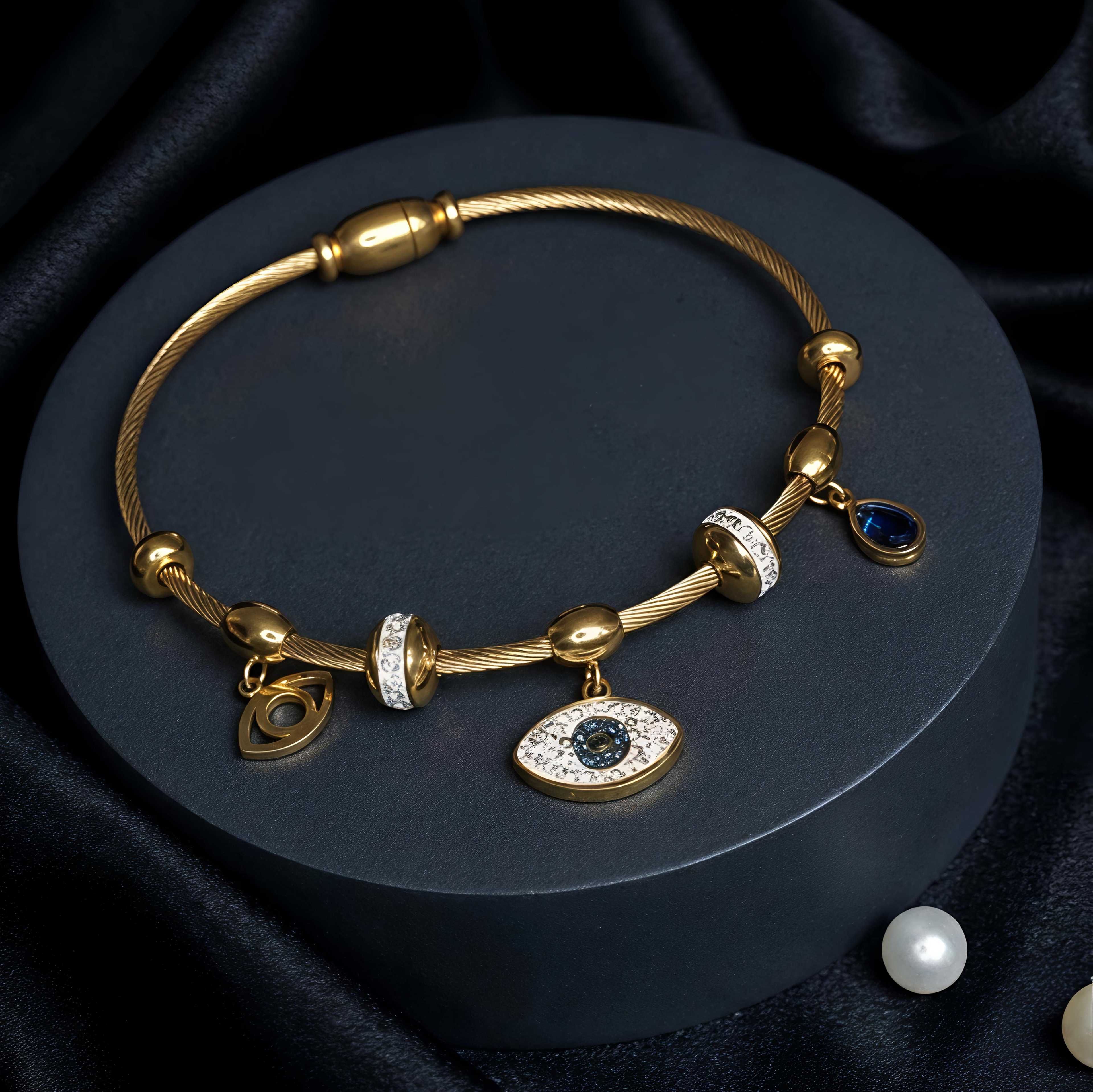 Tavisi Nazar Blue Charm Bracelet featuring an evil eye charm, blue crystal accents and anti-tarnish stainless steel construction.