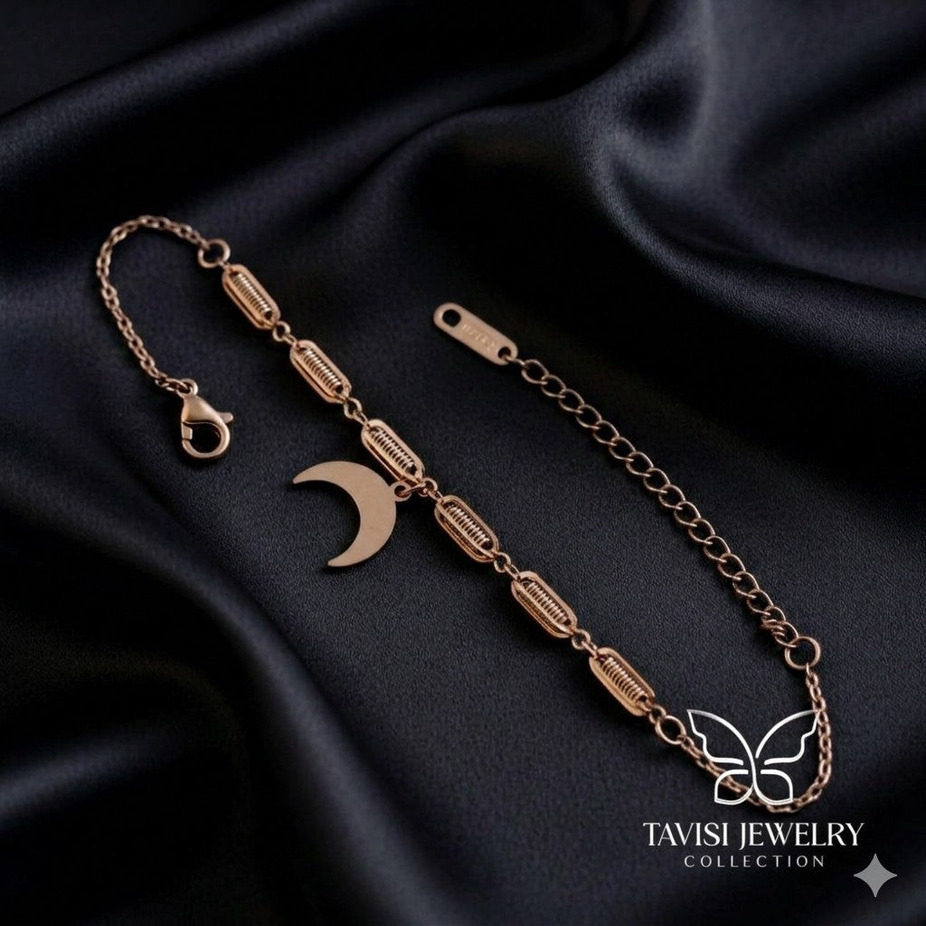 Rose Gold Crescent Moon Chain Bracelet on white fabric - Tavisi Jewelry Collection
