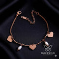 Rose Gold Heart Pearl Charm Bracelet with multiple heart charms on white background - Tavisi Jewelry Collection
