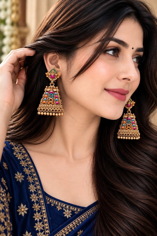 Woman wearing Saanvi premium brass Lakshmi temple jhumka earrings with multicolour detailing