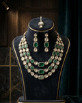 Sabyasachi inspired green Kundan AD bridal necklace set with matching earrings and maang tikka in premium brass.
