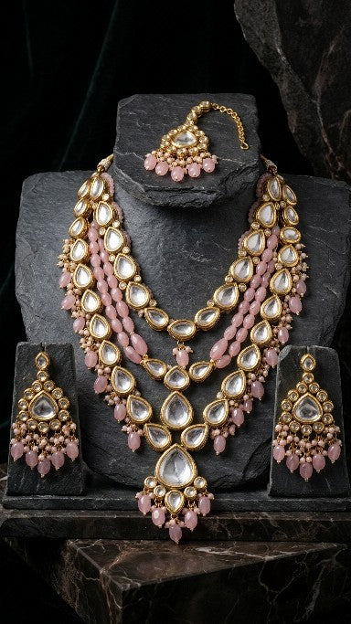 Sabyasachi inspired pink Kundan bridal necklace set with earrings and maang tikka in premium brass.