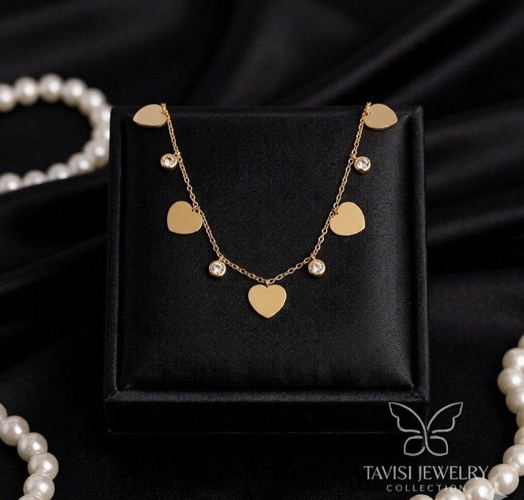 Tavisi Amora Gold Heart Charm Tanmaniya Necklace with premium AD American Diamond stones 316L surgical stainless steel and 22K anti tarnish finish 
 
