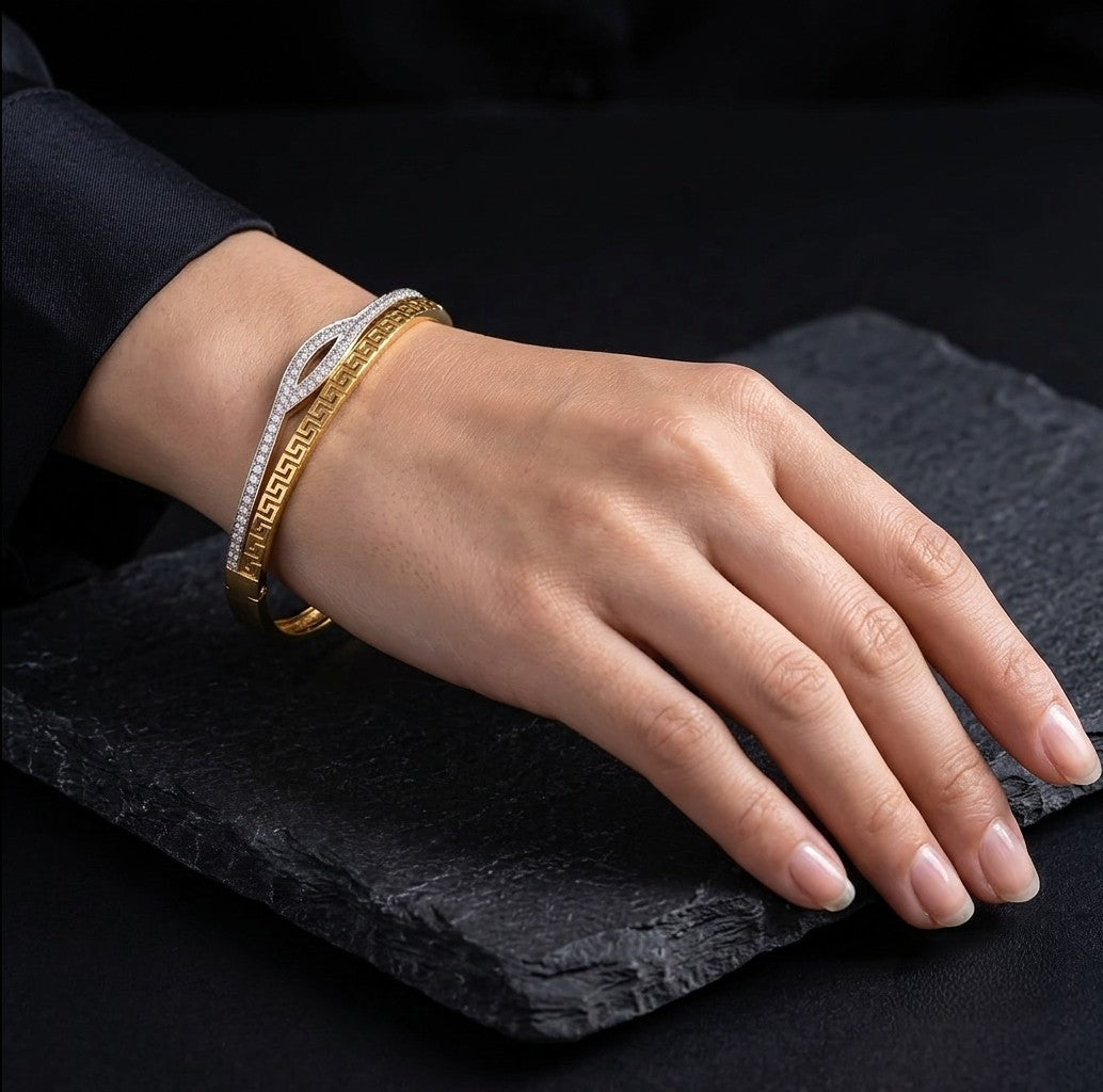 Gold plated AD stone wave pattern bracelet worn on a woman's wrist. 